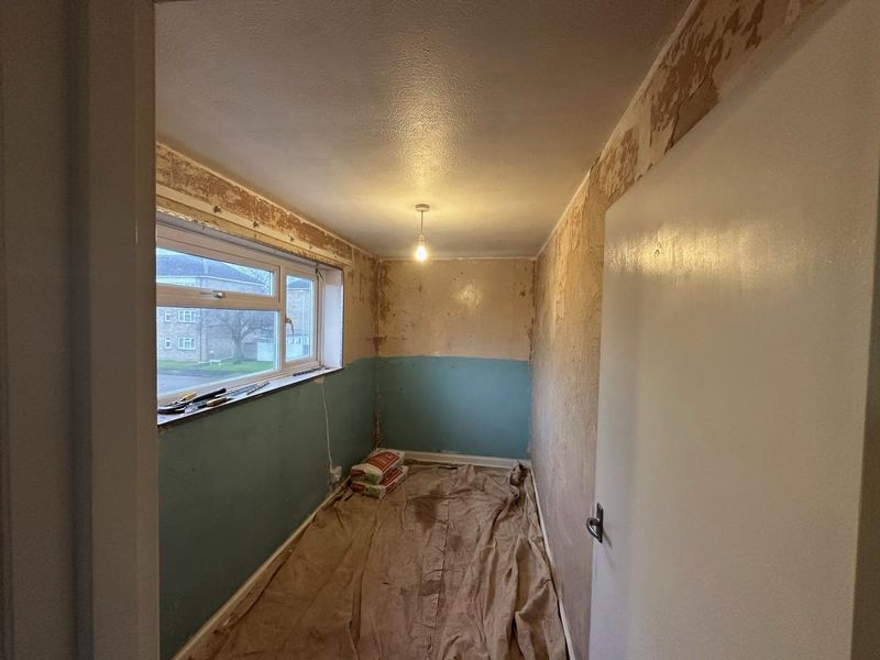 The box room from the doorway end, old plaster patchy